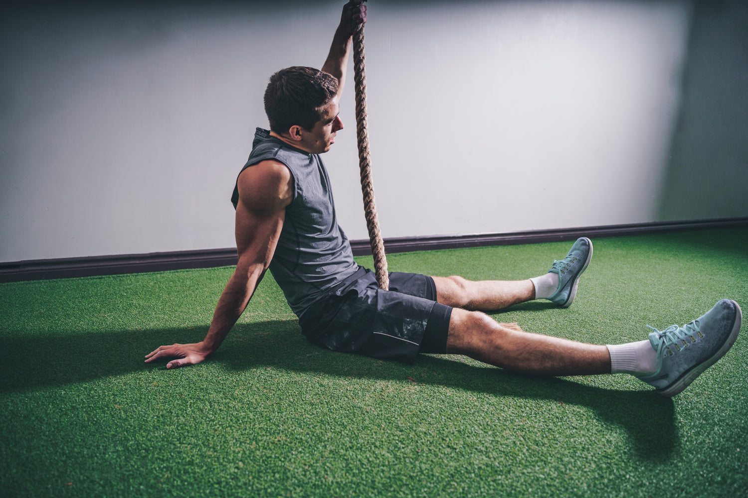 Gym workout man sits on floor