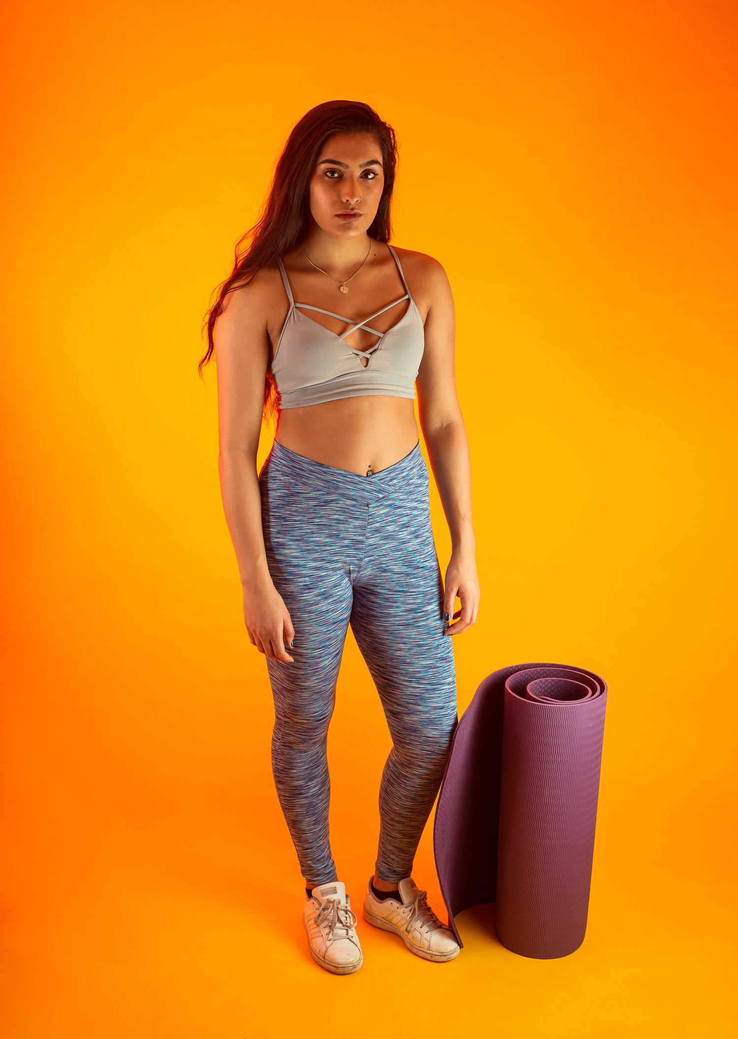 Woman ready for a yoga workout, focusing on posture improvement and back pain relief, preparing for a fitness session.